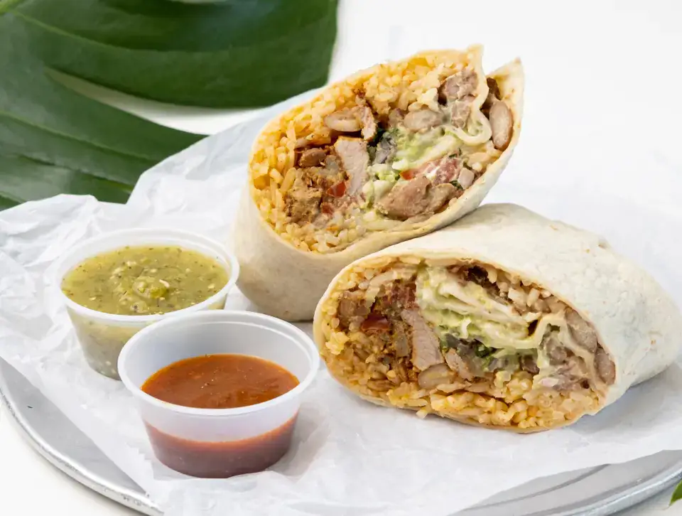 Mexican burrito served with salsas at Los Tacos Hermanos on Canal Street in SoHo, NYC