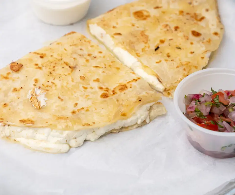 Mexican quesadilla from the menu at Los Tacos Hermanos on Canal Street in SoHo, NYC