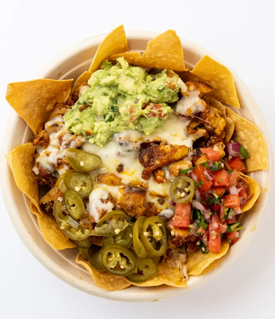 Loaded nachos with guacamole at Los Tacos Hermanos on Canal Street in SoHo, NYC