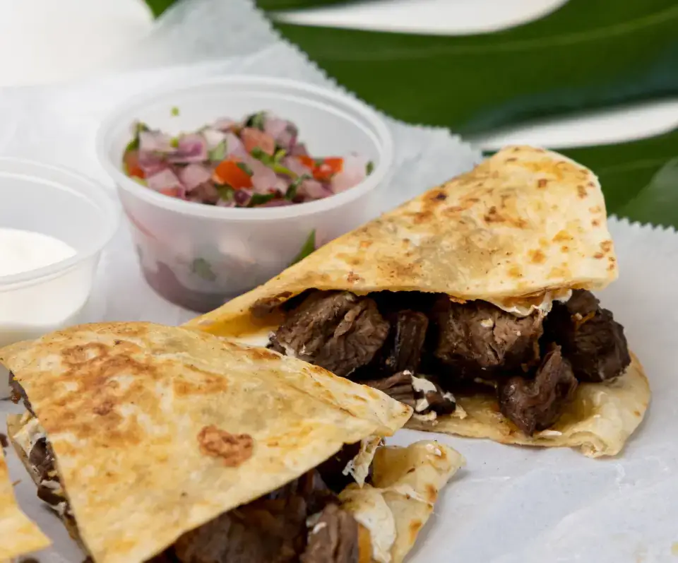 Mexican quesadilla from the menu at Los Tacos Hermanos on Canal Street in SoHo, NYC